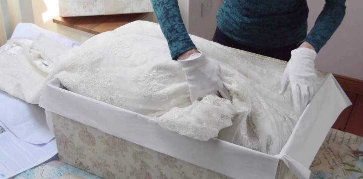 How do you store a wedding dress in a box?